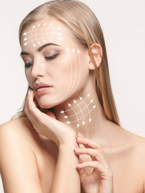 Woman with arrows drawn on her face and neck, indicating facial treatment zones