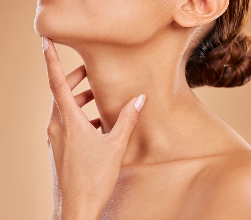 Woman tilting head up with hand on neck and chin