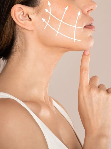 Close-up of woman’s face with chin resting on finger and white lines