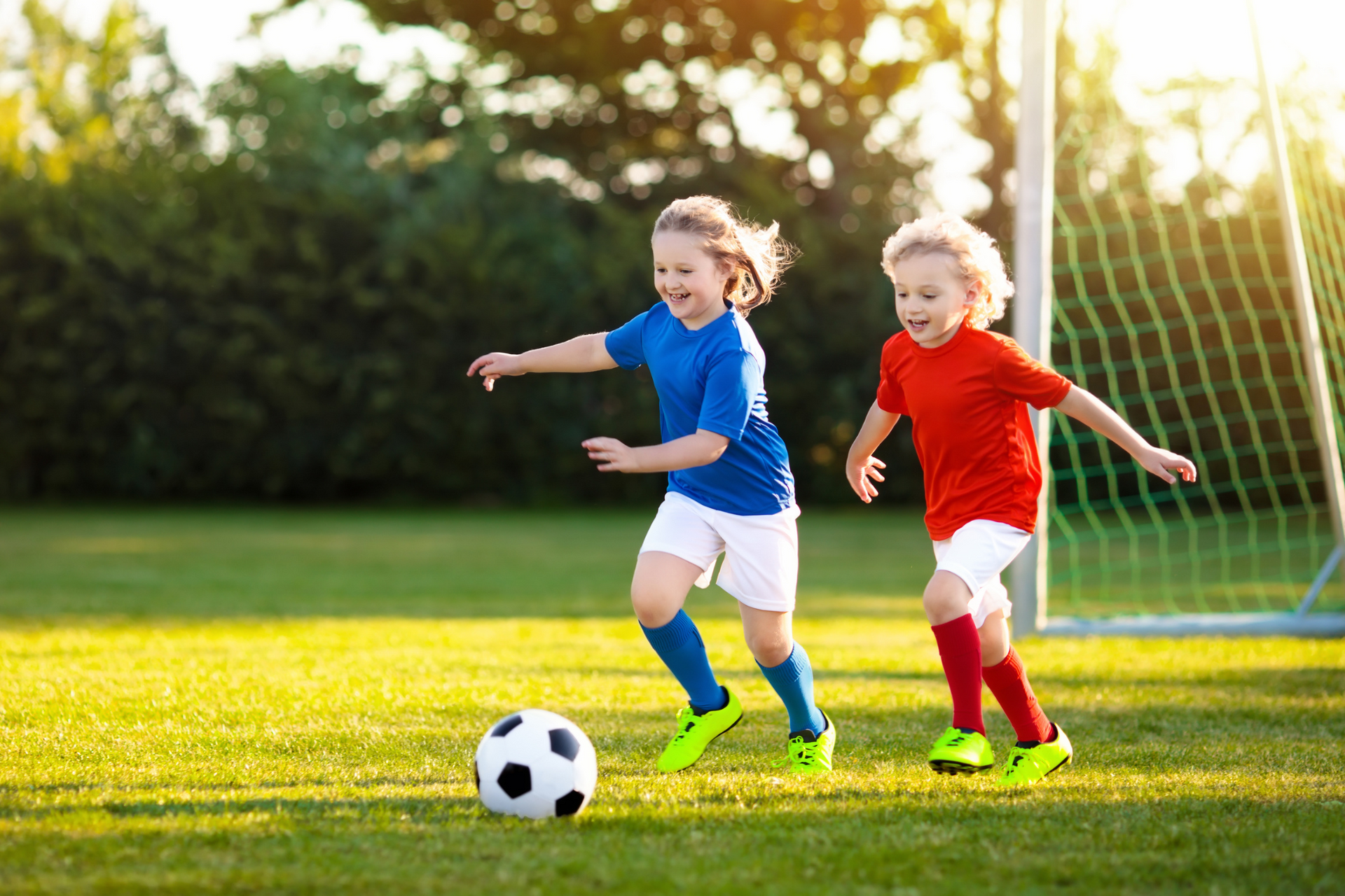 Two children who have recently undergone sports physicals are now playing soccer on the field.