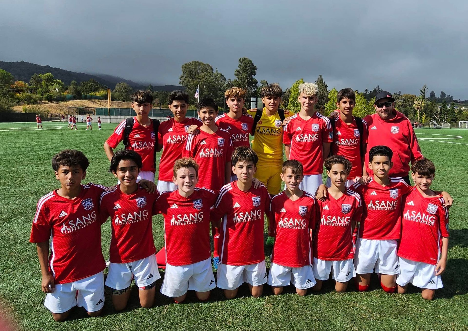 Young athletes pose for a group photo after their soccer practice.