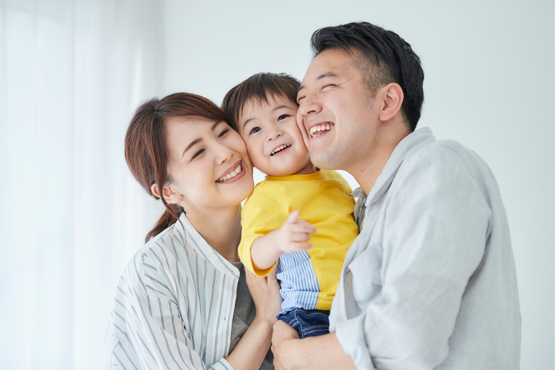 Happy parents embracing their child who is growing strong with a healthy BMI.