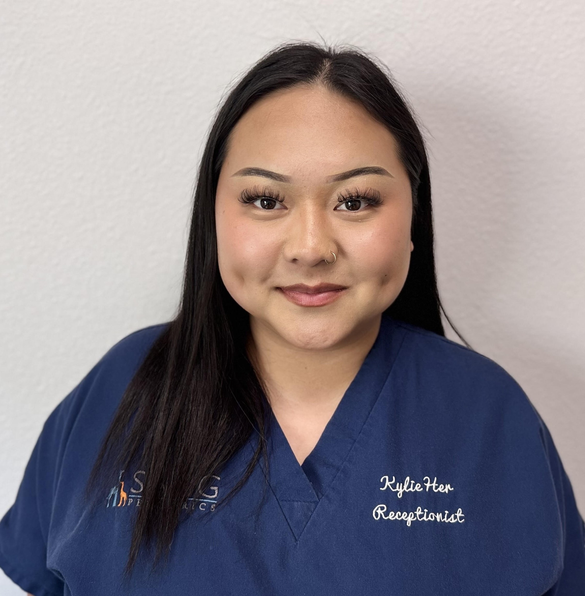The woman is wearing a black shirt and smiling for the camera.
