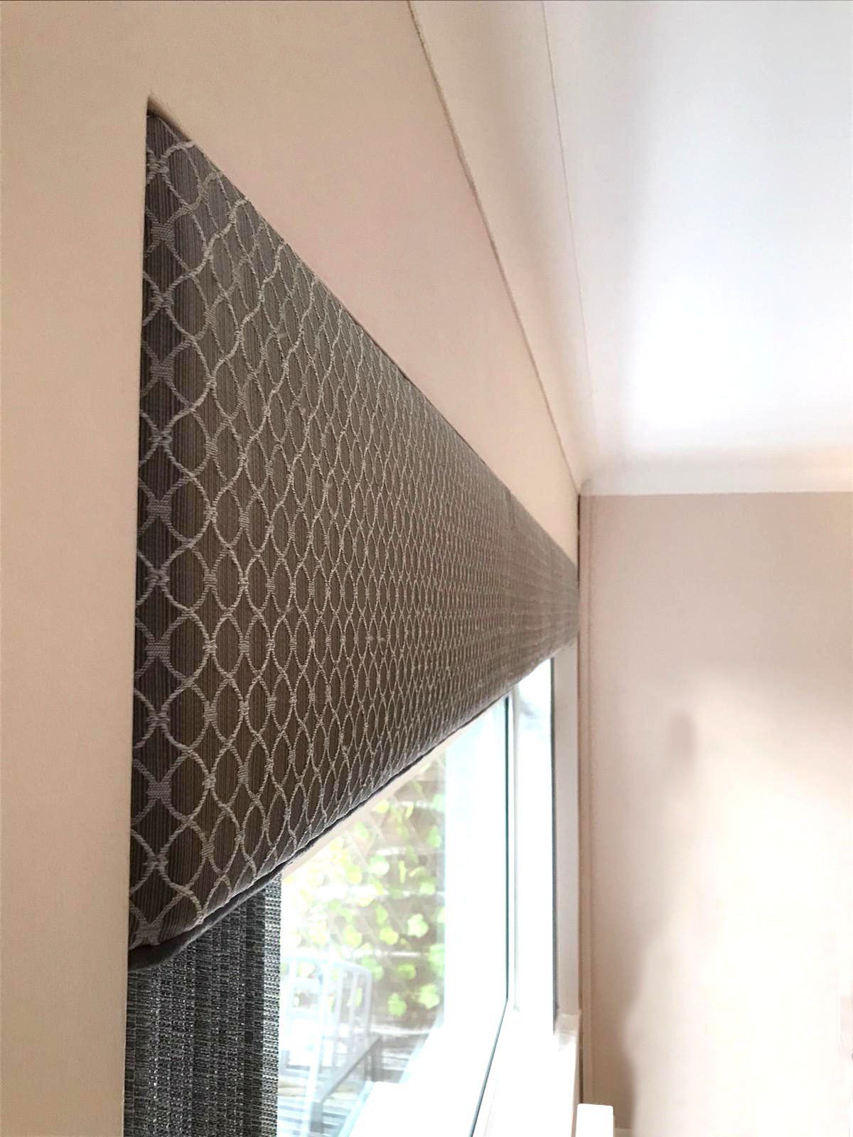 A window with a blind on it in a room.