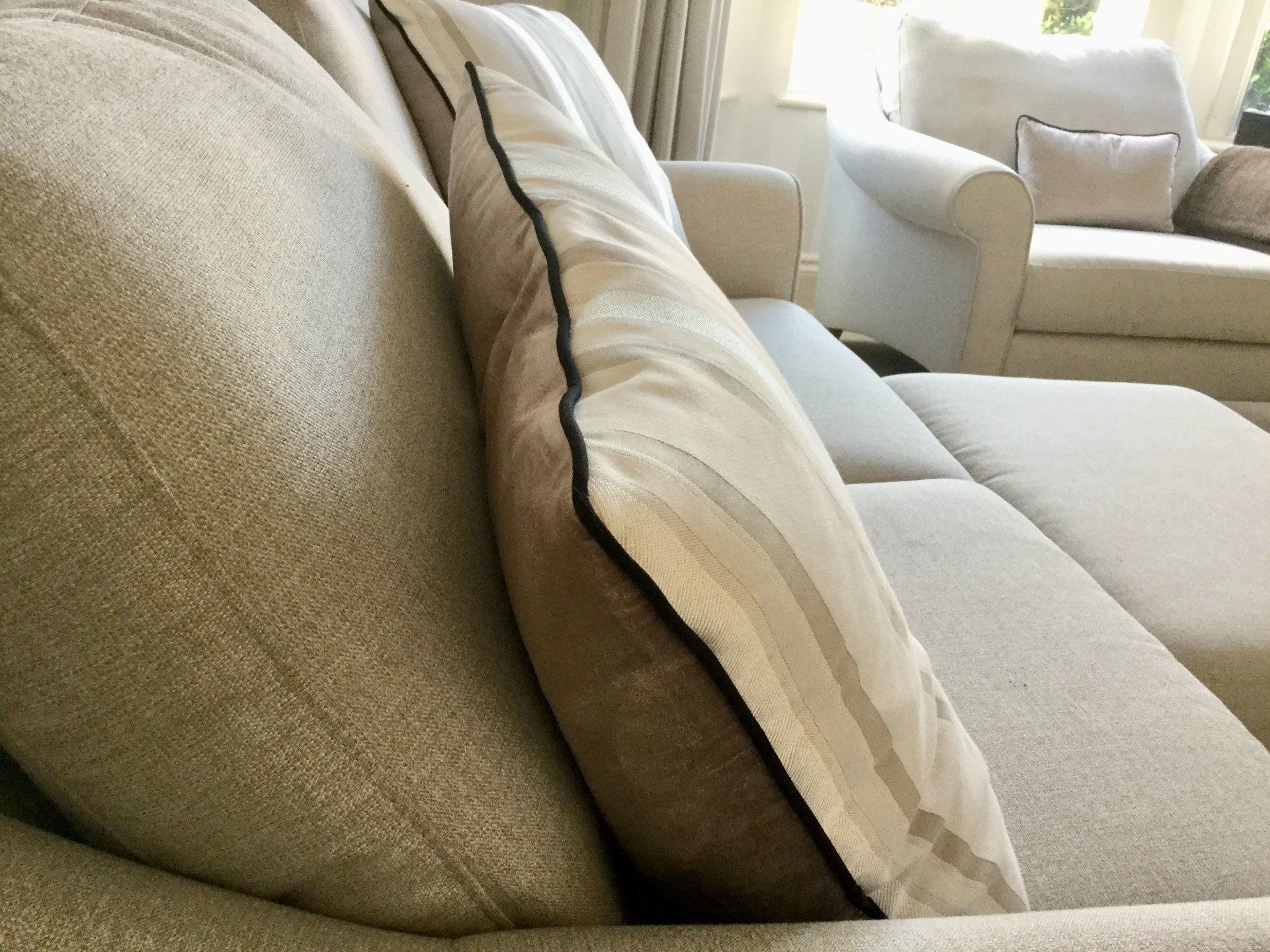 A couch with two pillows on it in a living room