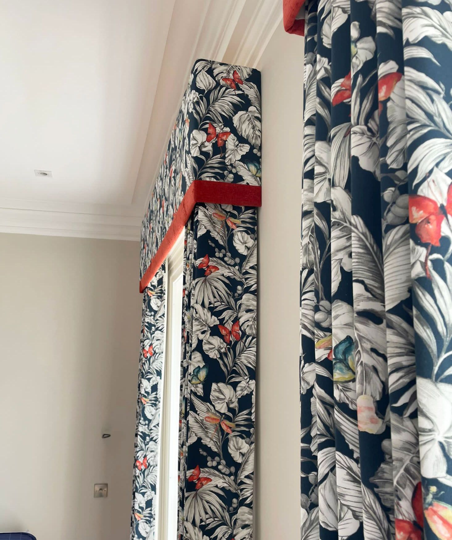 A pair of curtains with a floral pattern on them
