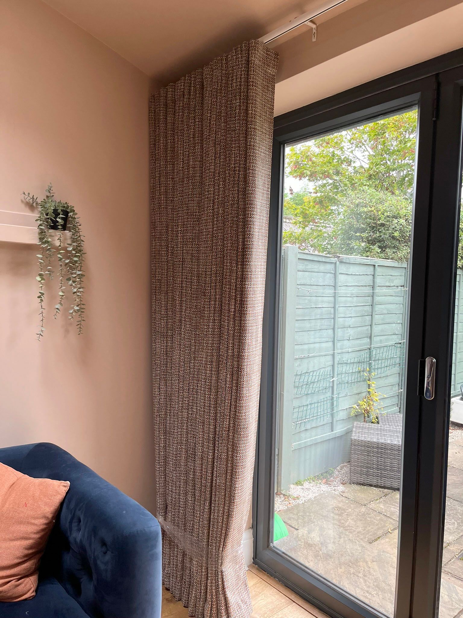 A living room with a sliding glass door and a couch.