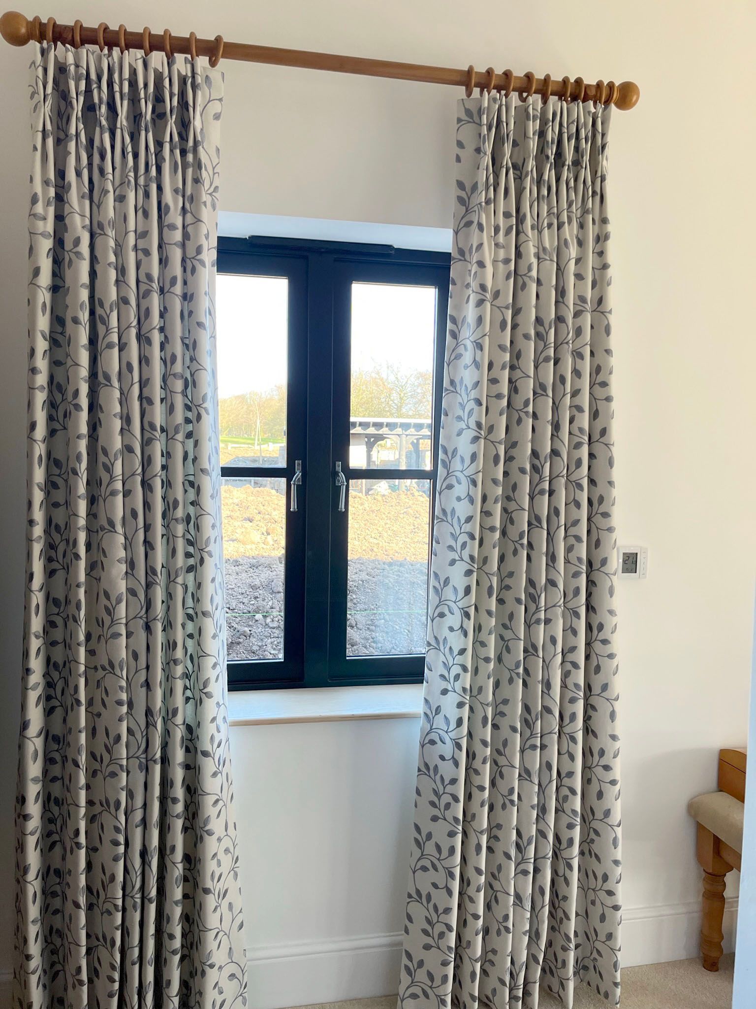 A pair of curtains are hanging on a window in a room.