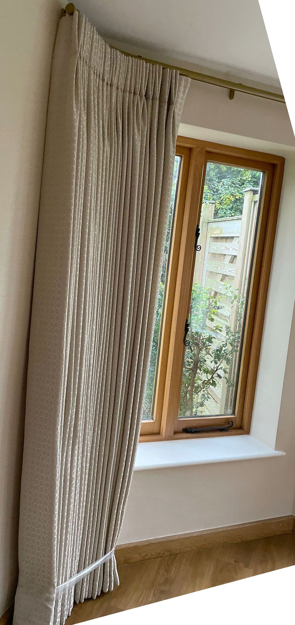 A room with a window and curtains on the wall.