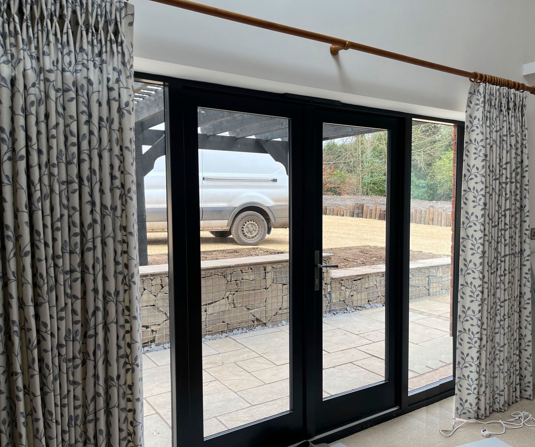 A living room with sliding glass doors and curtains.
