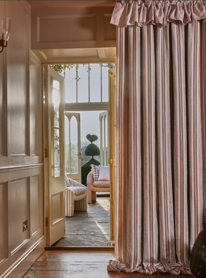 A room with a striped curtain hanging on the wall