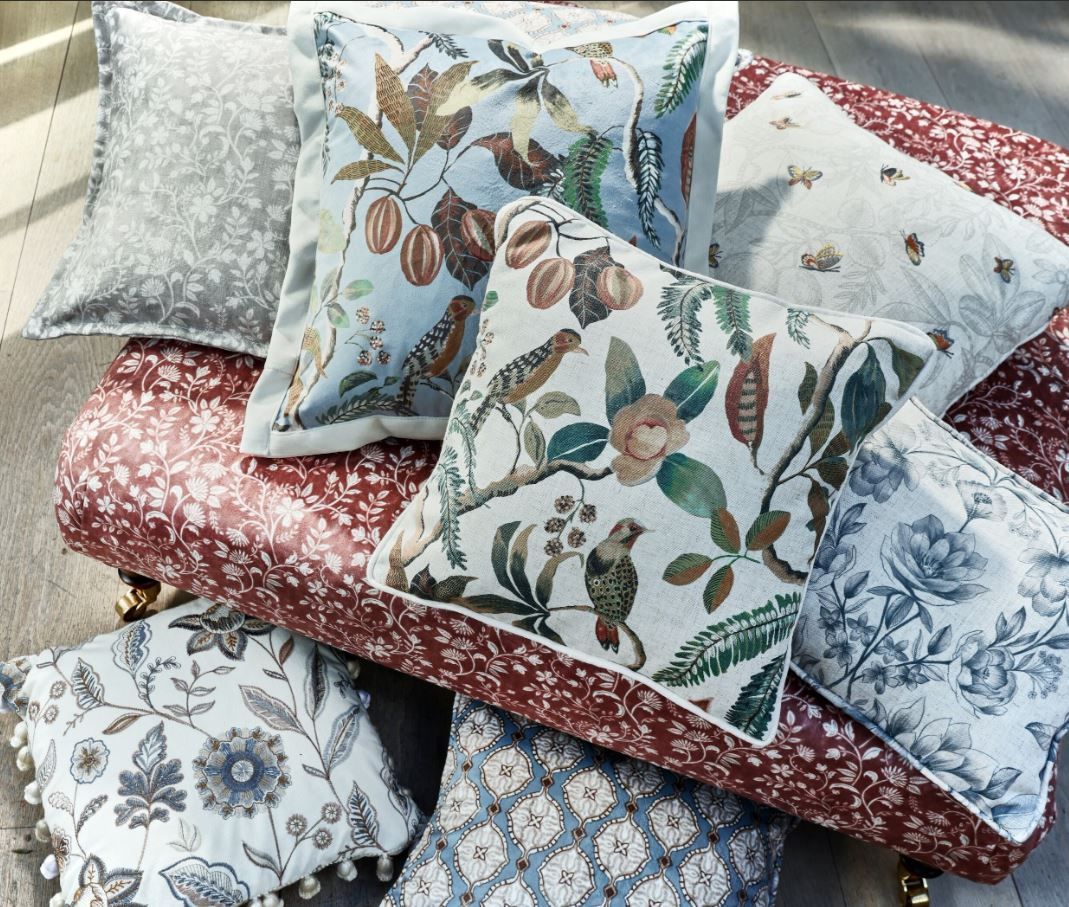 A bunch of pillows are stacked on top of each other on a couch.