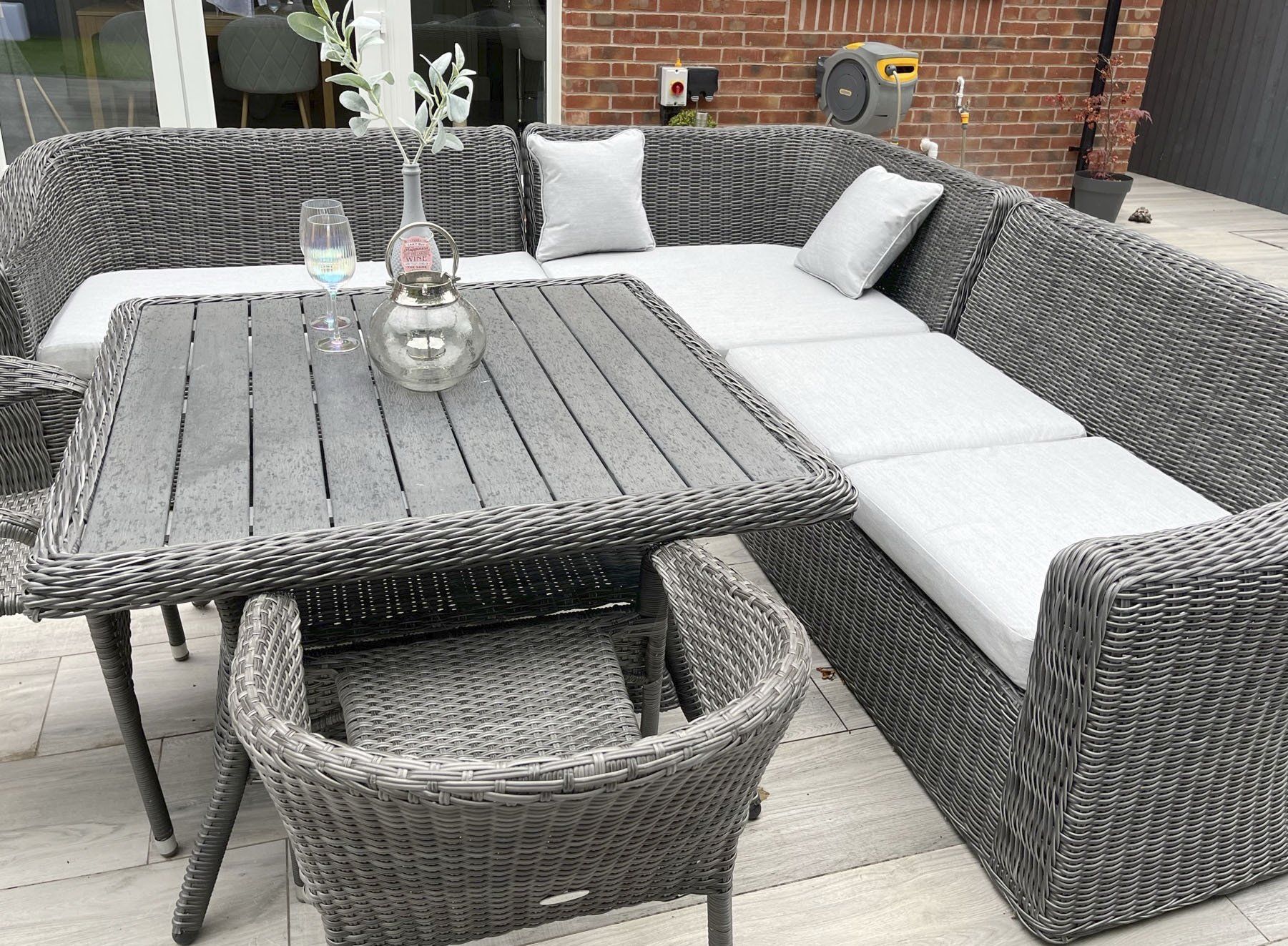 A wicker patio set with a table and chairs