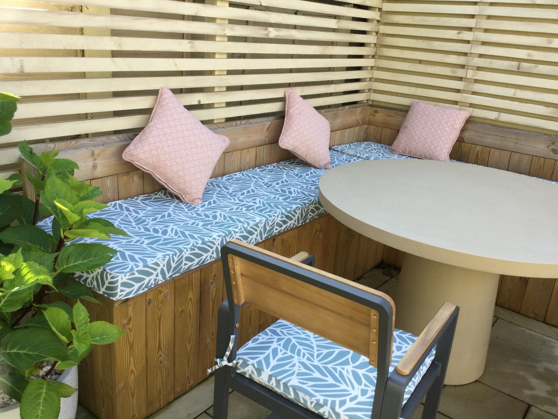 There is a table and chairs in the corner of the room.