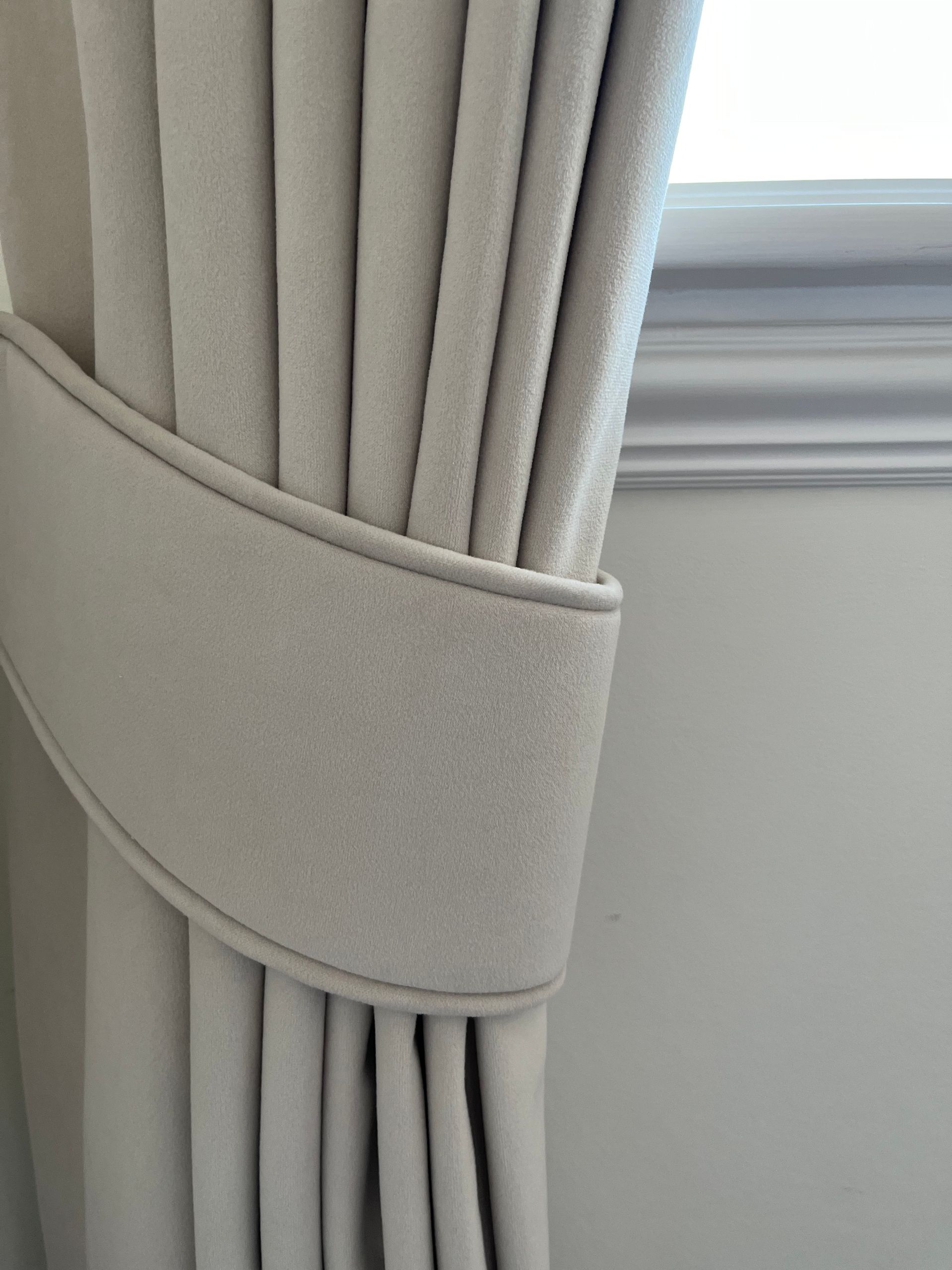 A close up of a curtain tie back