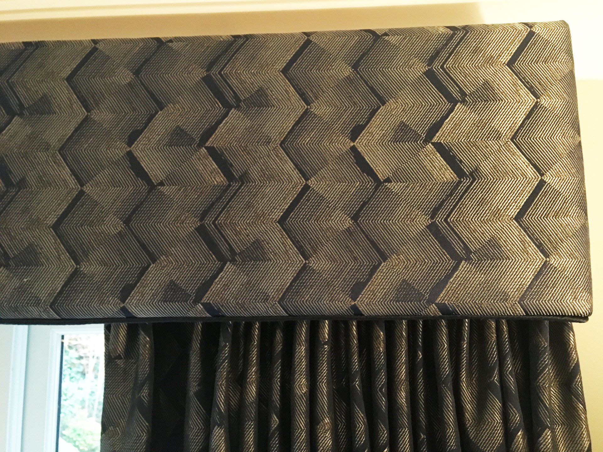 A navy blue pelmet with a chevron pattern on it