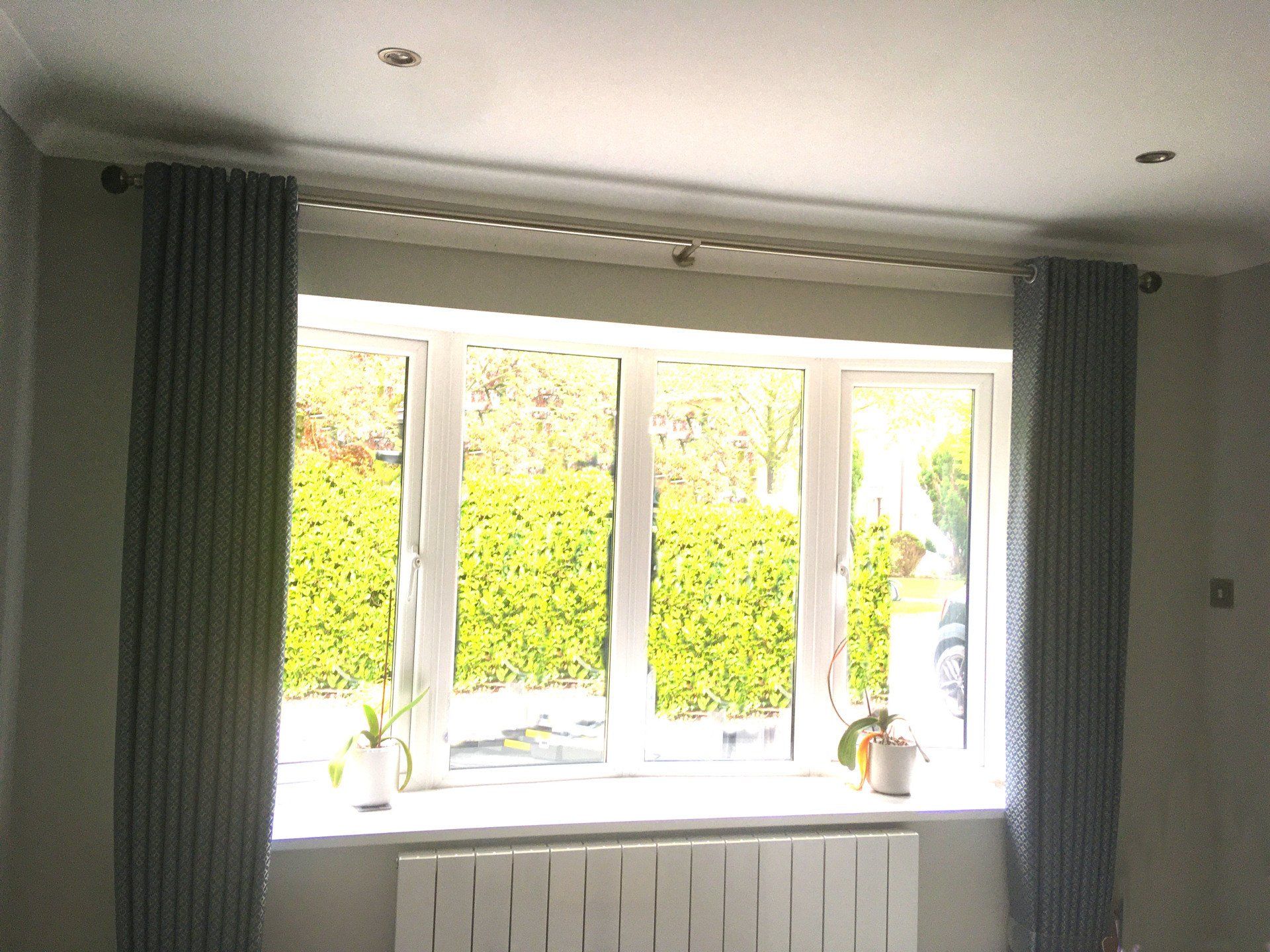 A living room with a window and a radiator
