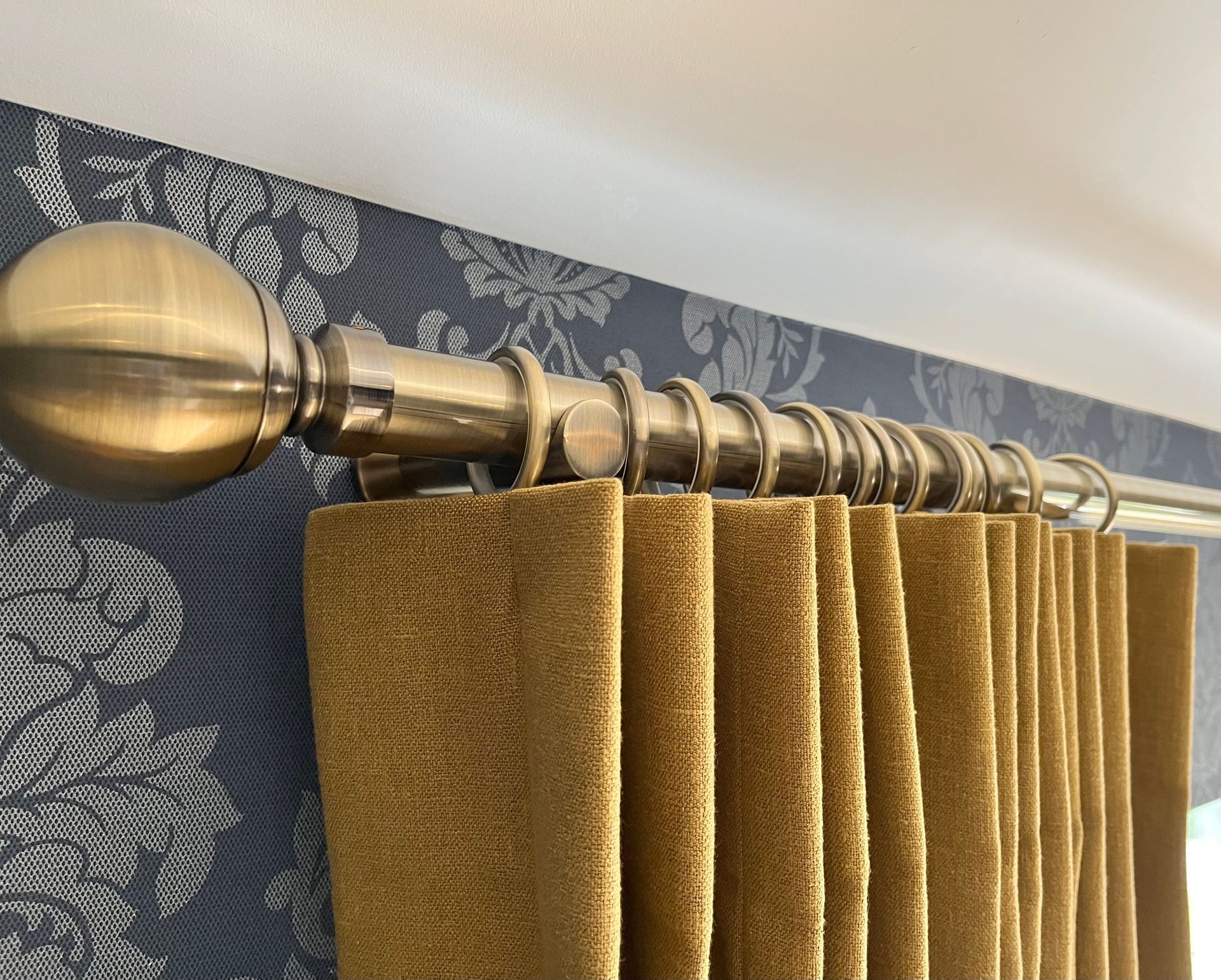 Brass pole with gold velvet curtain