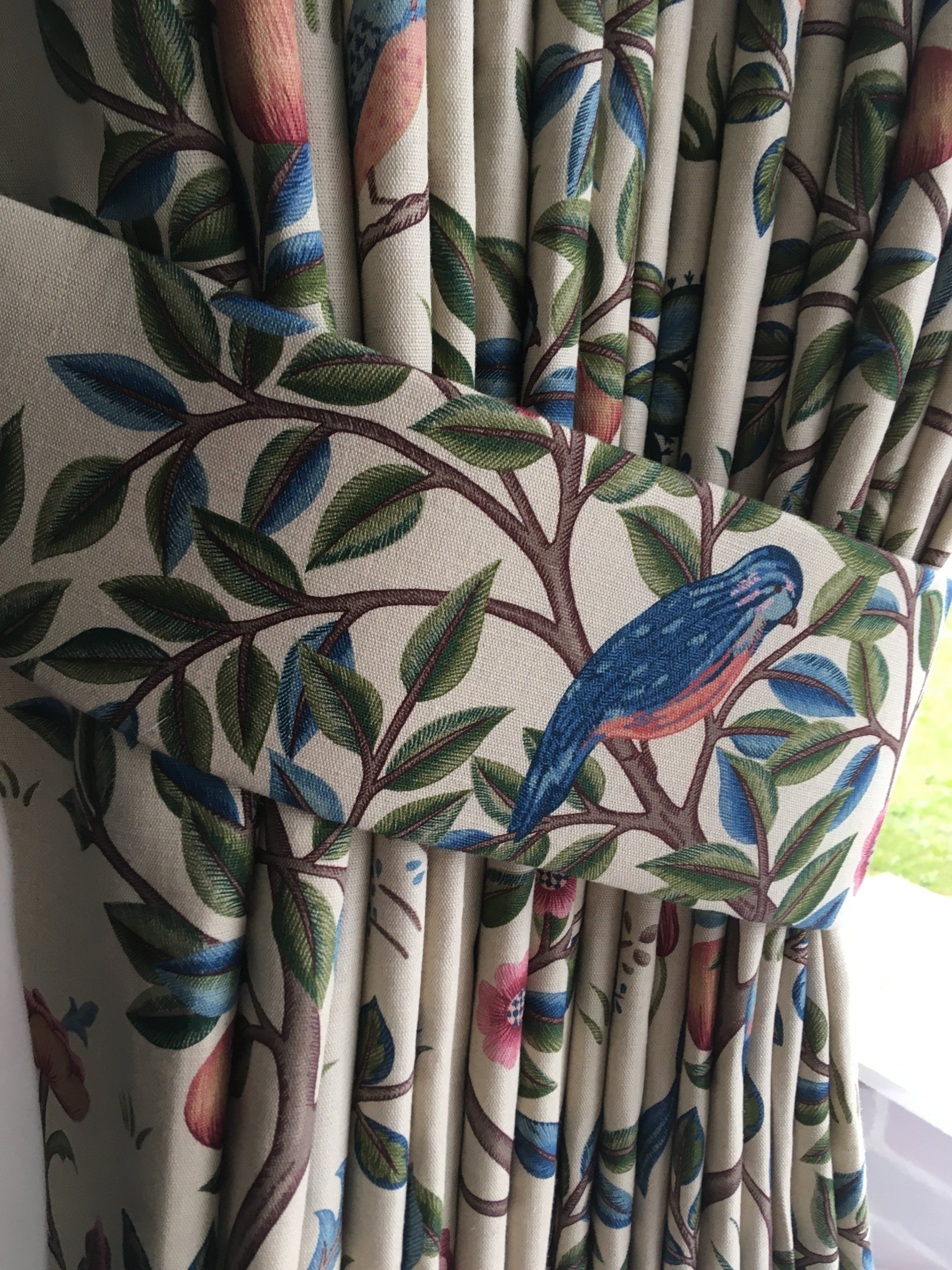 A close up of a pair of curtains with birds on them.