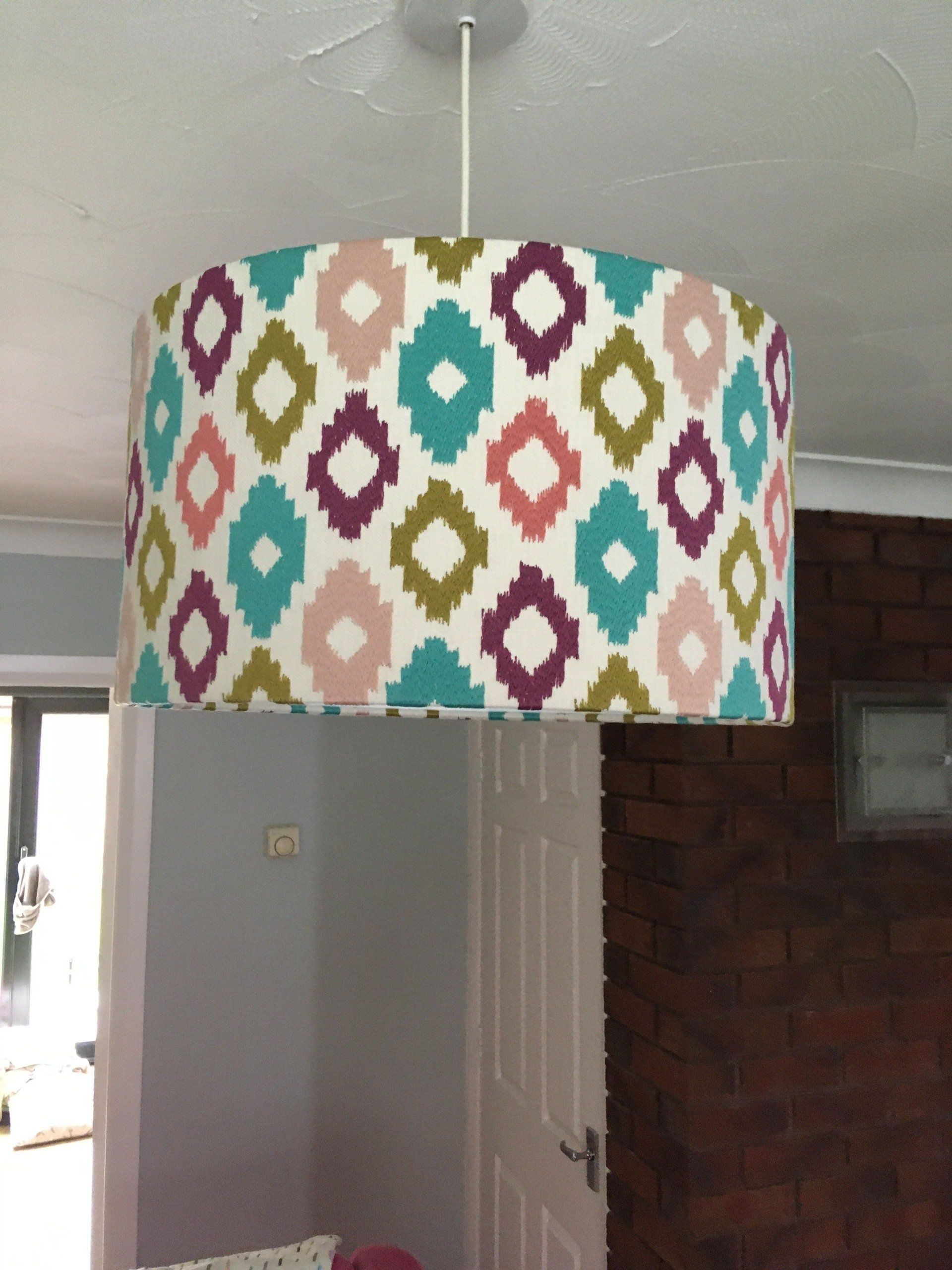 A colorful lampshade is hanging from the ceiling in a room