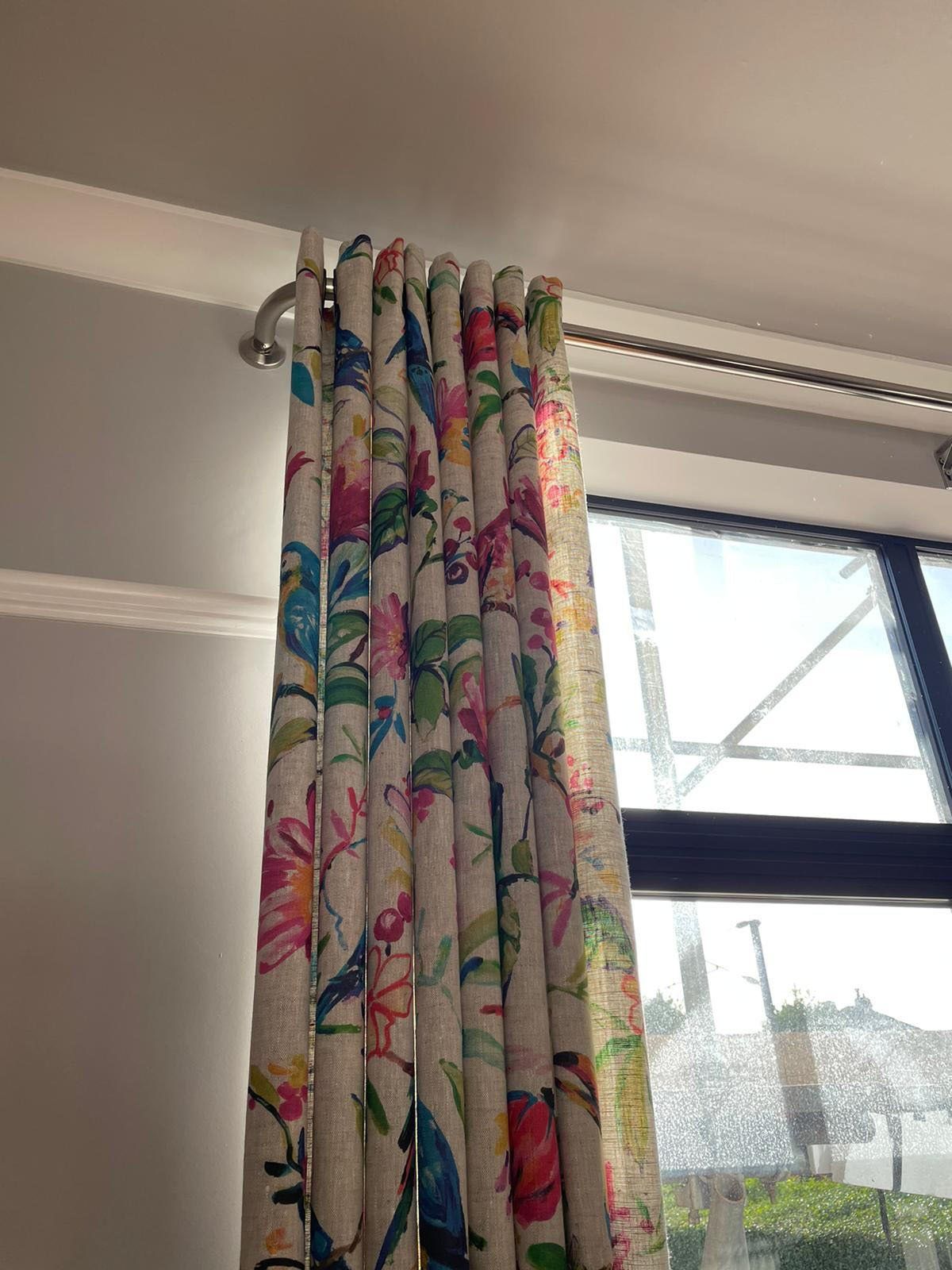 A pair of colorful curtains are hanging on a window.