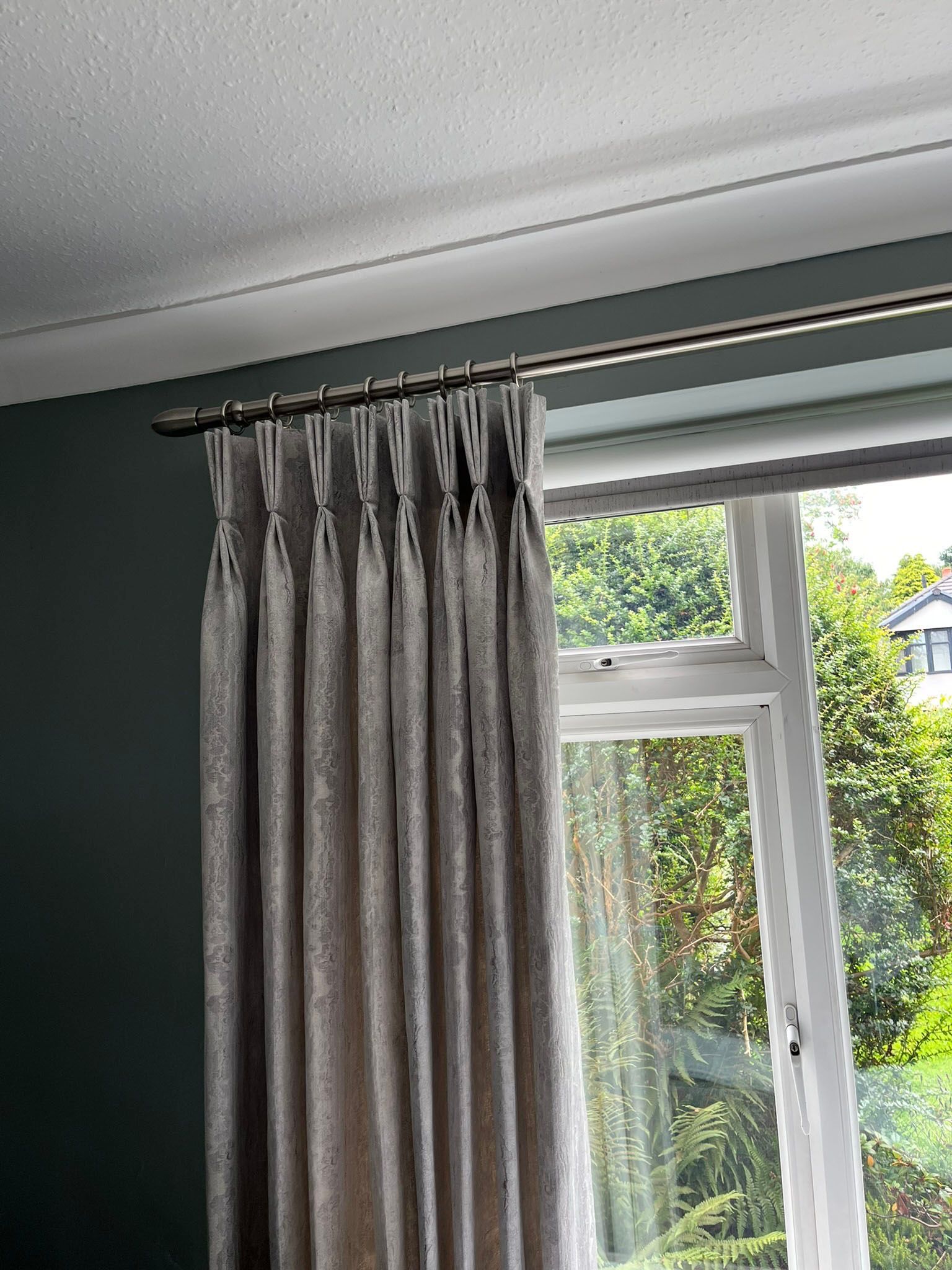 A close up of a window with curtains on it.