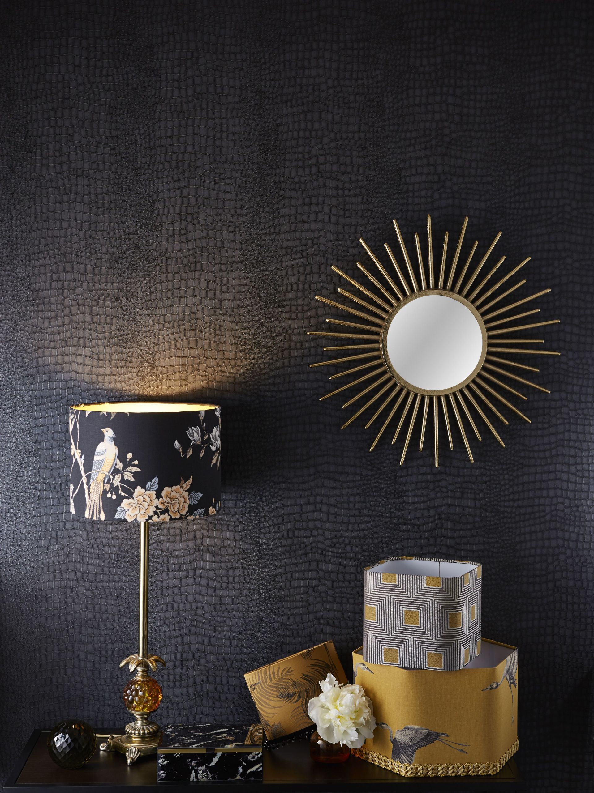 A table with a lamp and a mirror on it