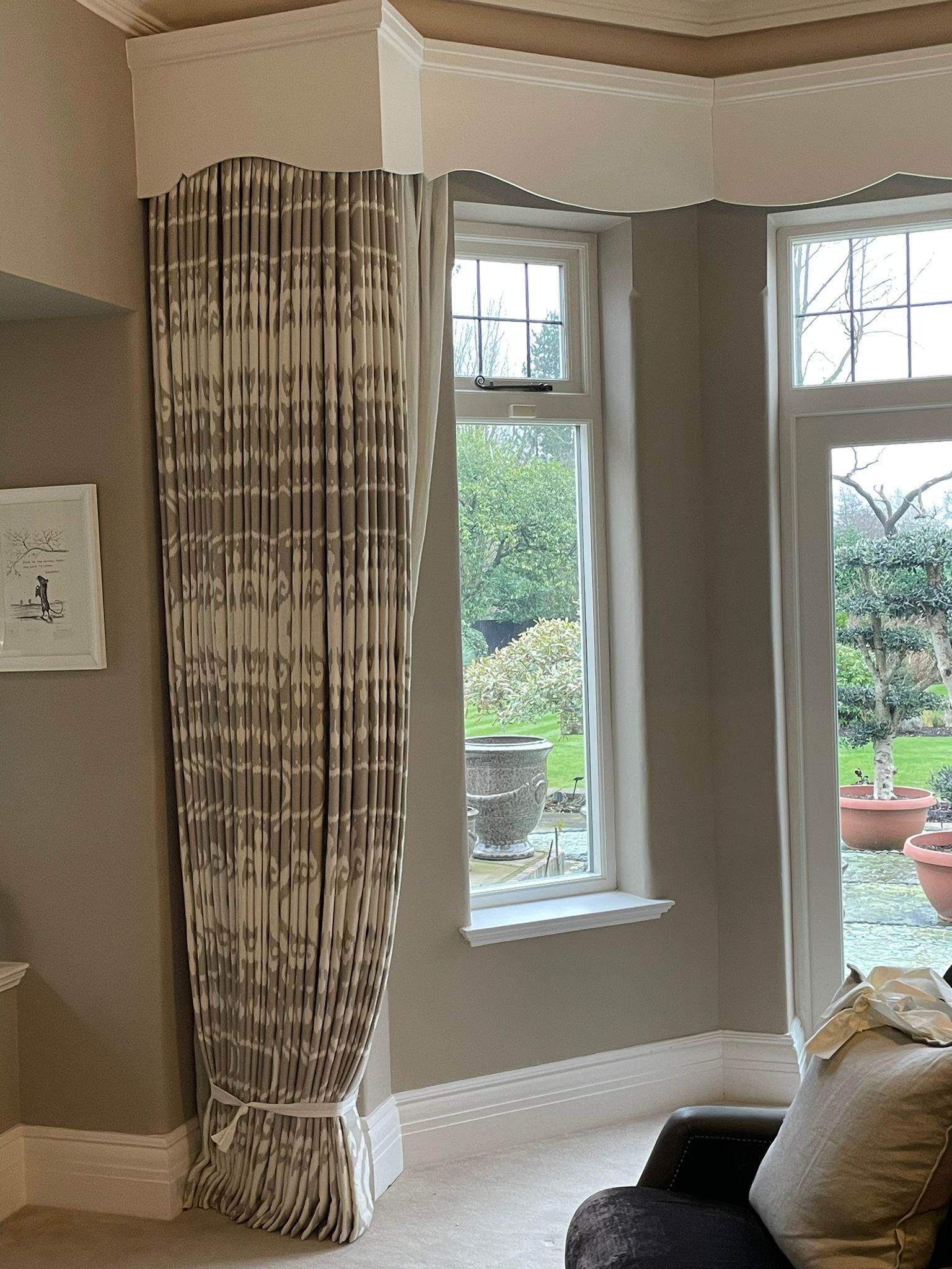 A living room with a large window and a chair