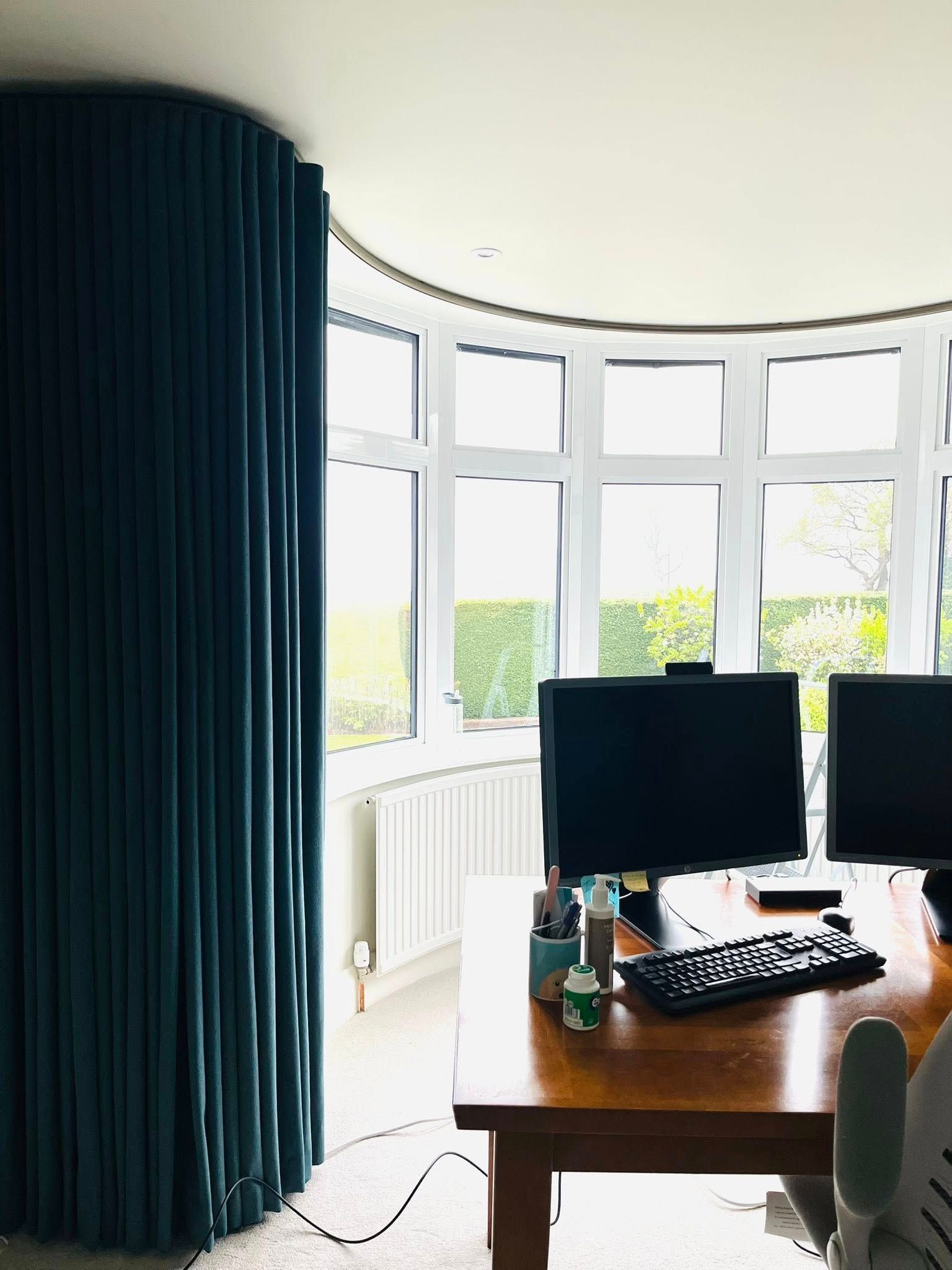 A desk with two computer monitors and a keyboard on it
