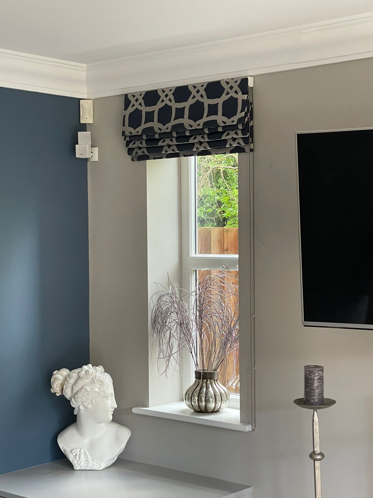 There is a statue of a woman on the table in the living room.