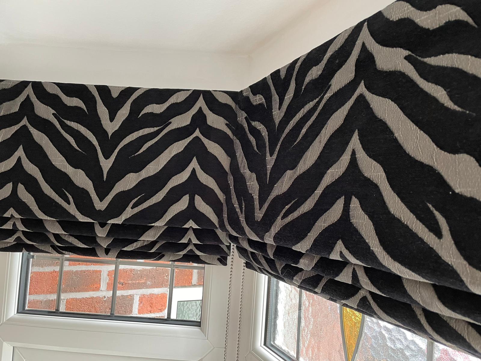 A window with zebra print blinds on it