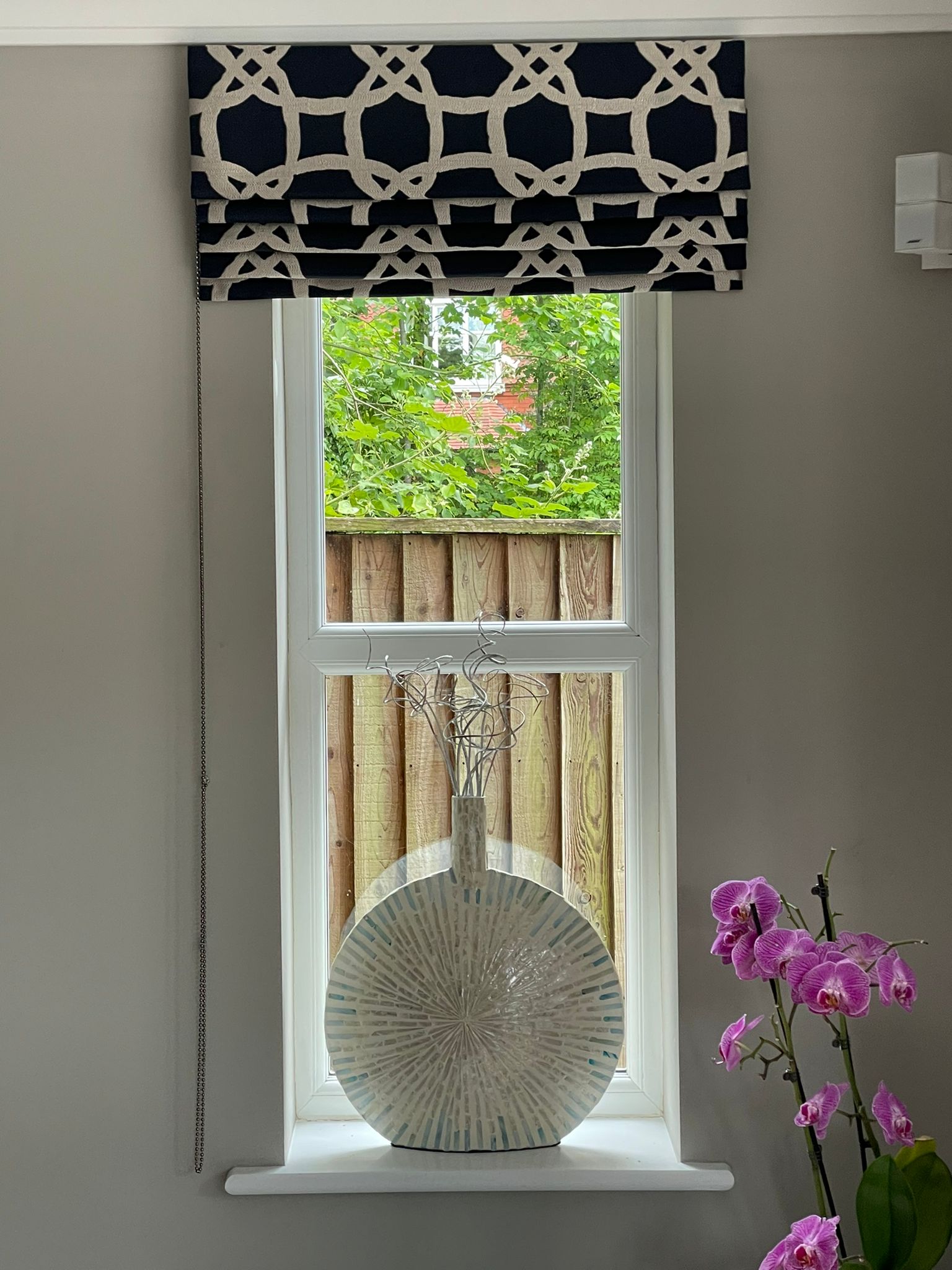 A vase is sitting on a window sill in a living room.