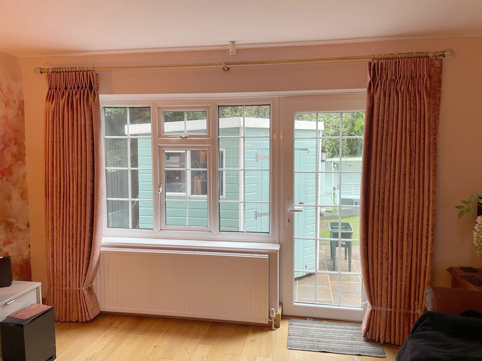 A living room with a large window and a sliding glass door.