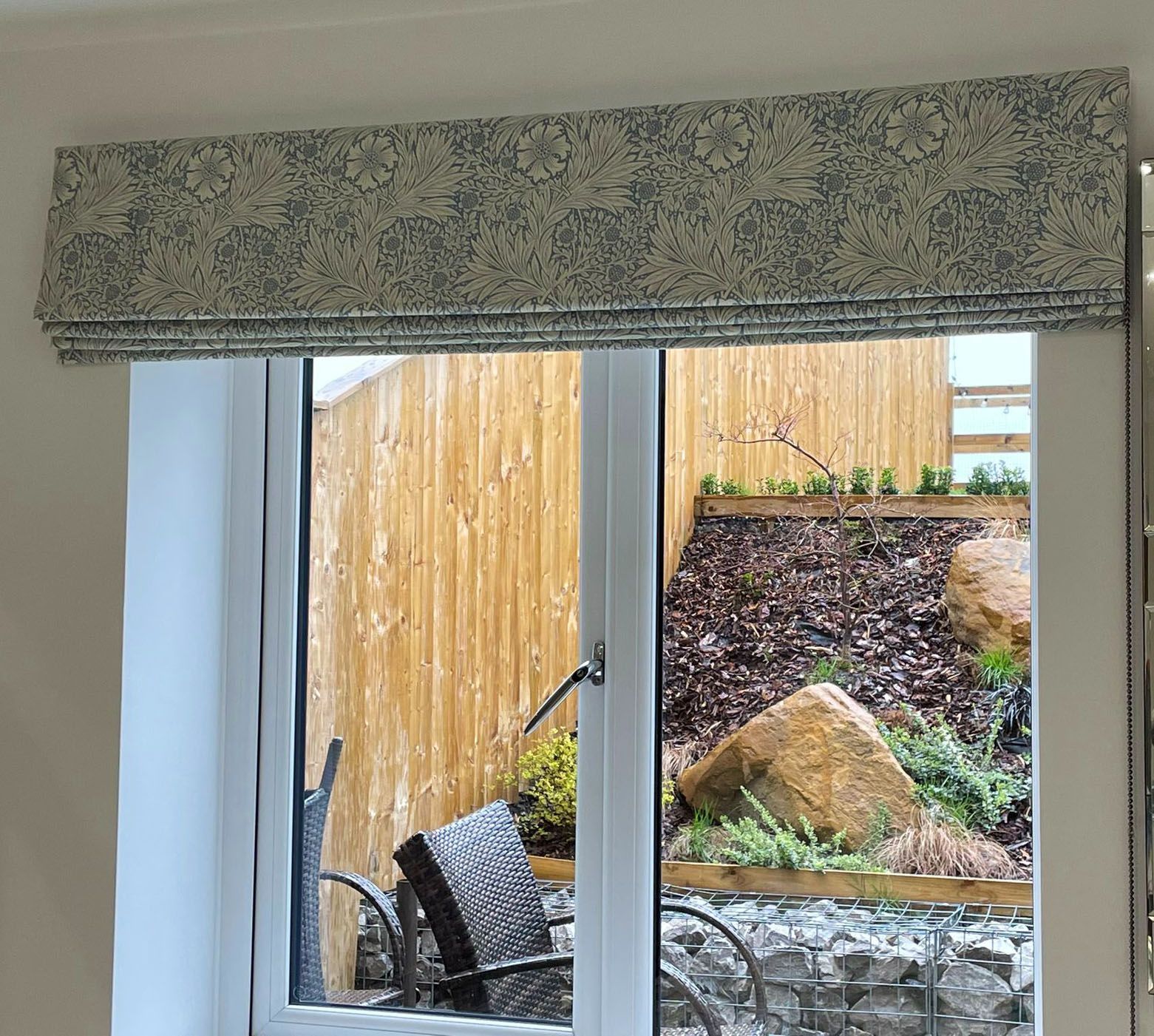 A window with a wicker chair in front of it