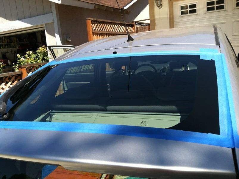 Car with windows taped for tinting