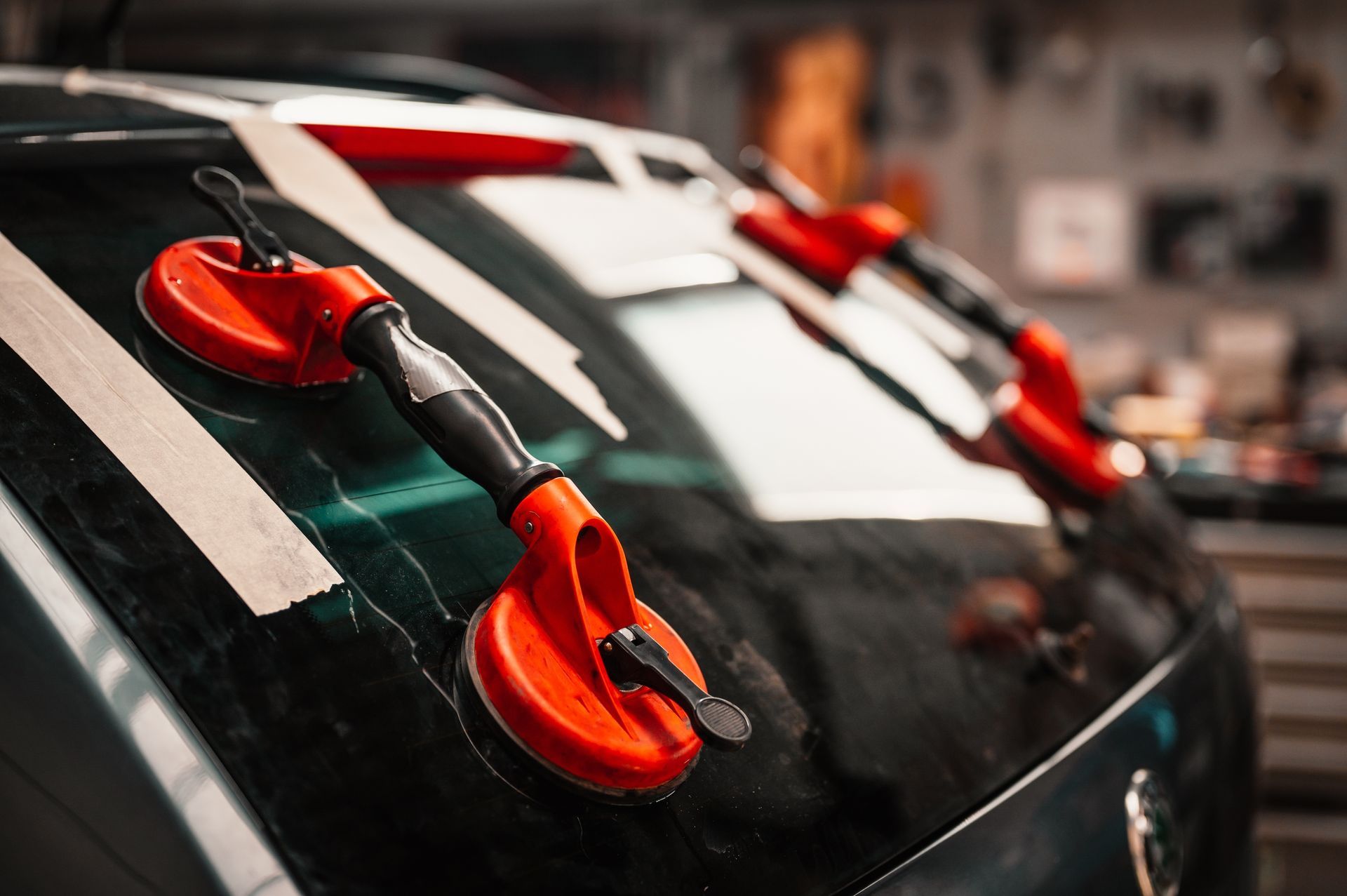 Red suction cups attached to car's rear window
