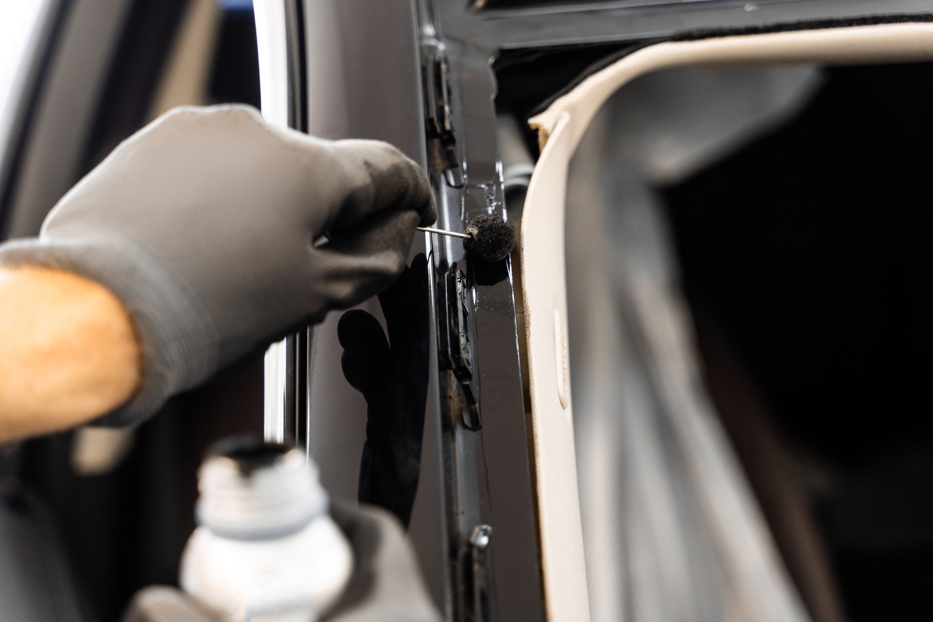 Applying sealant to a car door frame