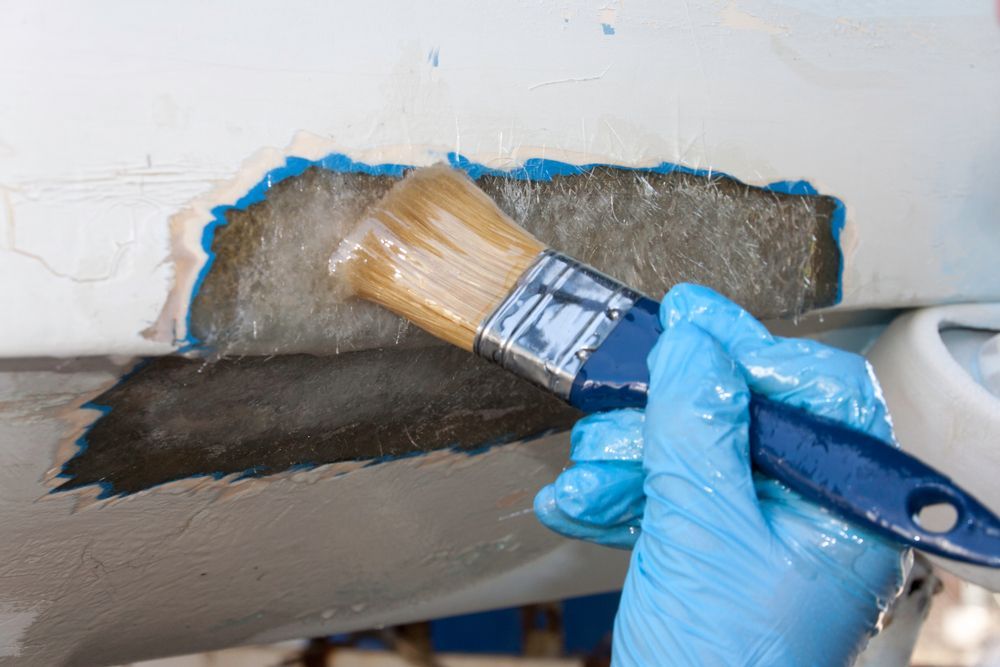 A Person is Holding a Brush Over a Piece of Wood — Panel Pro Smash Repairs in Wodonga, VIC