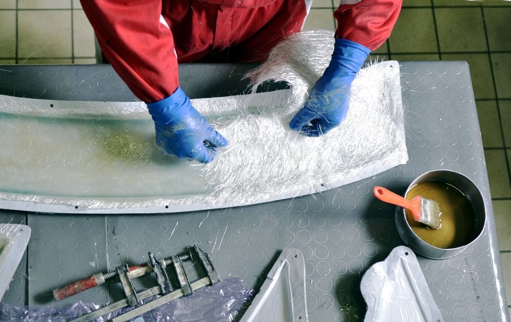 A Person is Working on a Piece of Foam on a Table — Panel Pro Smash Repairs in Wodonga, VIC