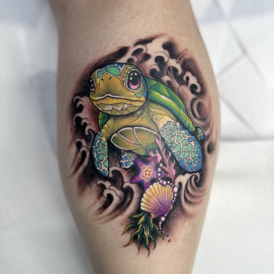 Tattoo of a cute sea turtle in the ocean. Features waves, coral, and a seashell with vibrant colors. — Whitsunday Tattooing Airlie Beach in Whitsundays, QLD