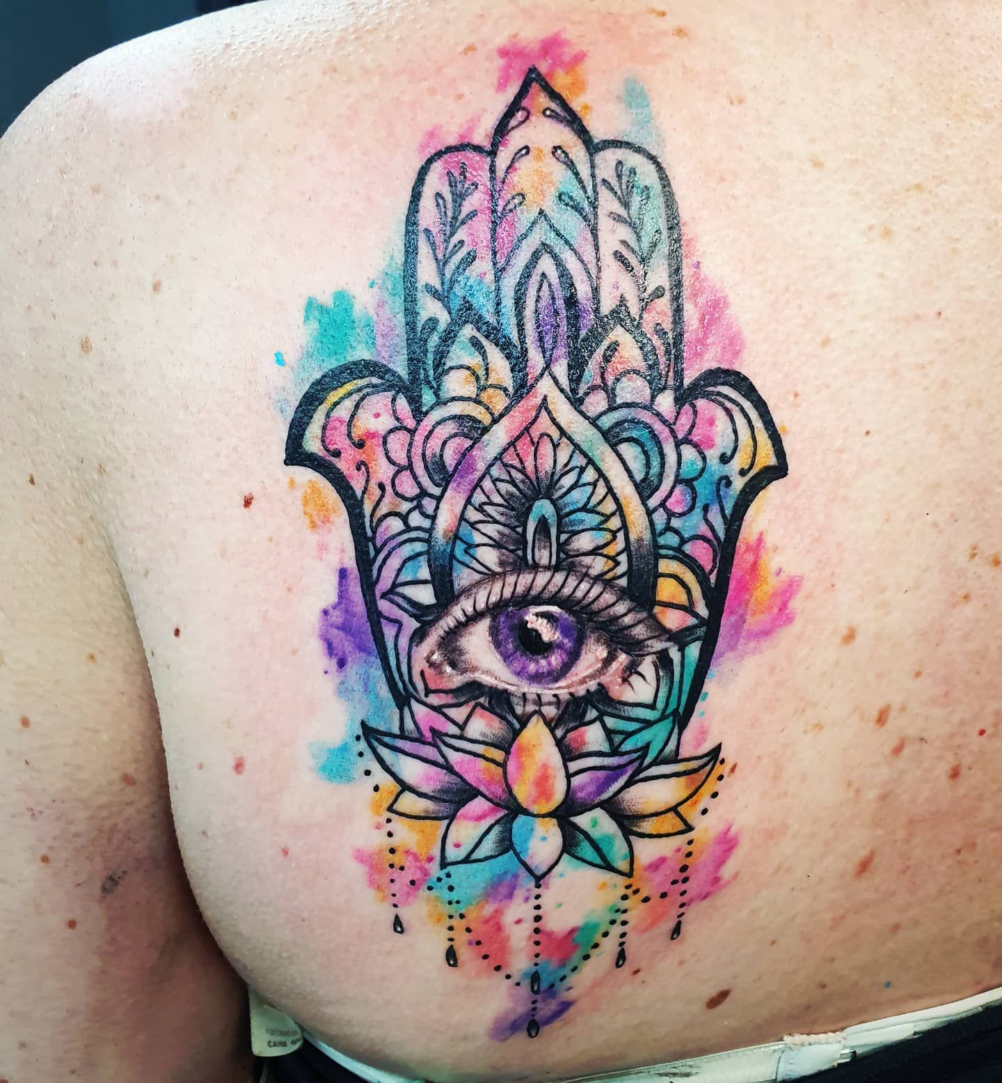 Watercolor Hamsa Hand Tattoo on Back — Whitsunday Tattooing Airlie Beach in Airlie Beach, QLD