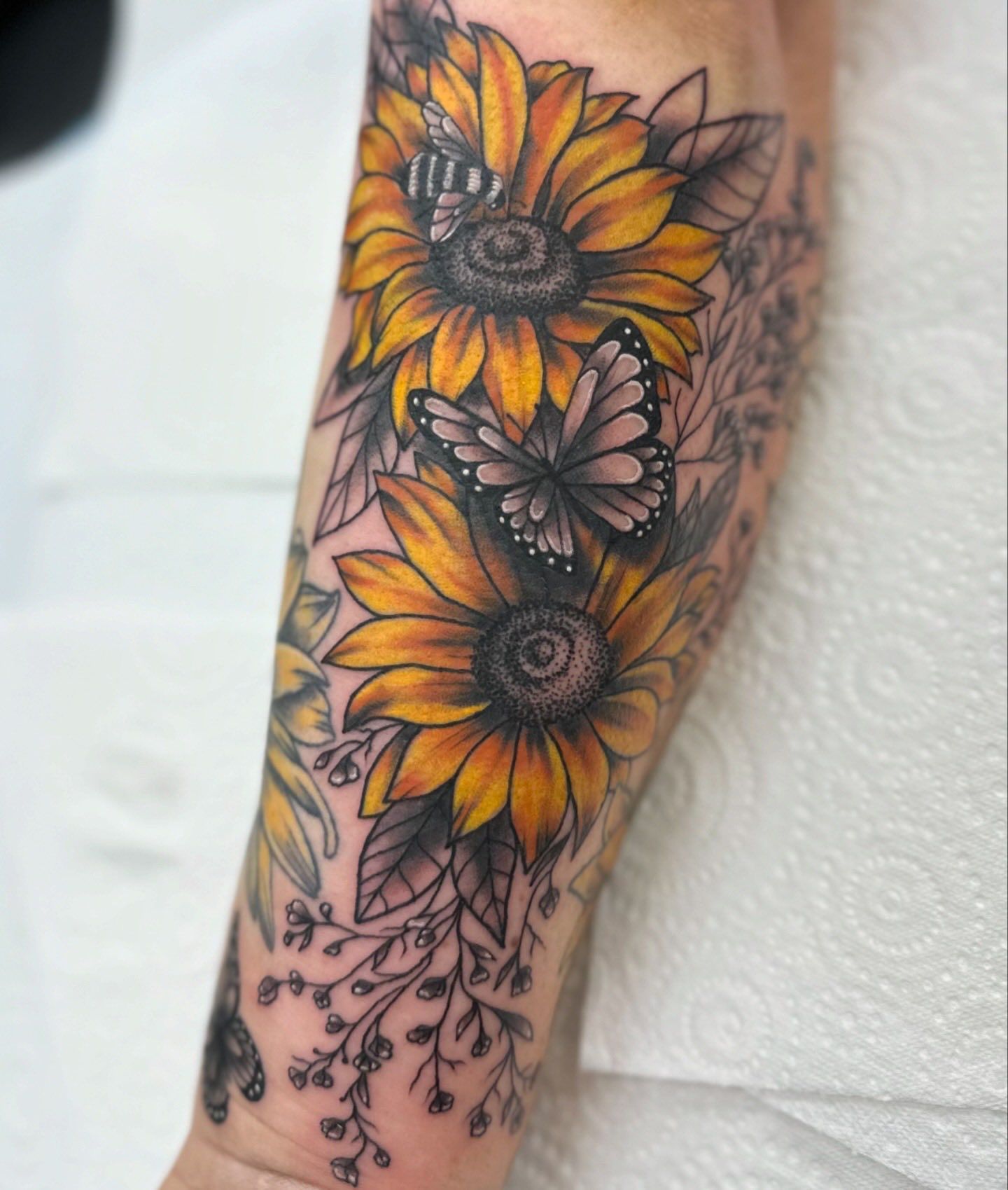 Sunflower Tattoo With Yellow Petals, Butterflies, and Leaves on Arm — Whitsunday Tattooing Airlie Beach in Airlie Beach, QLD