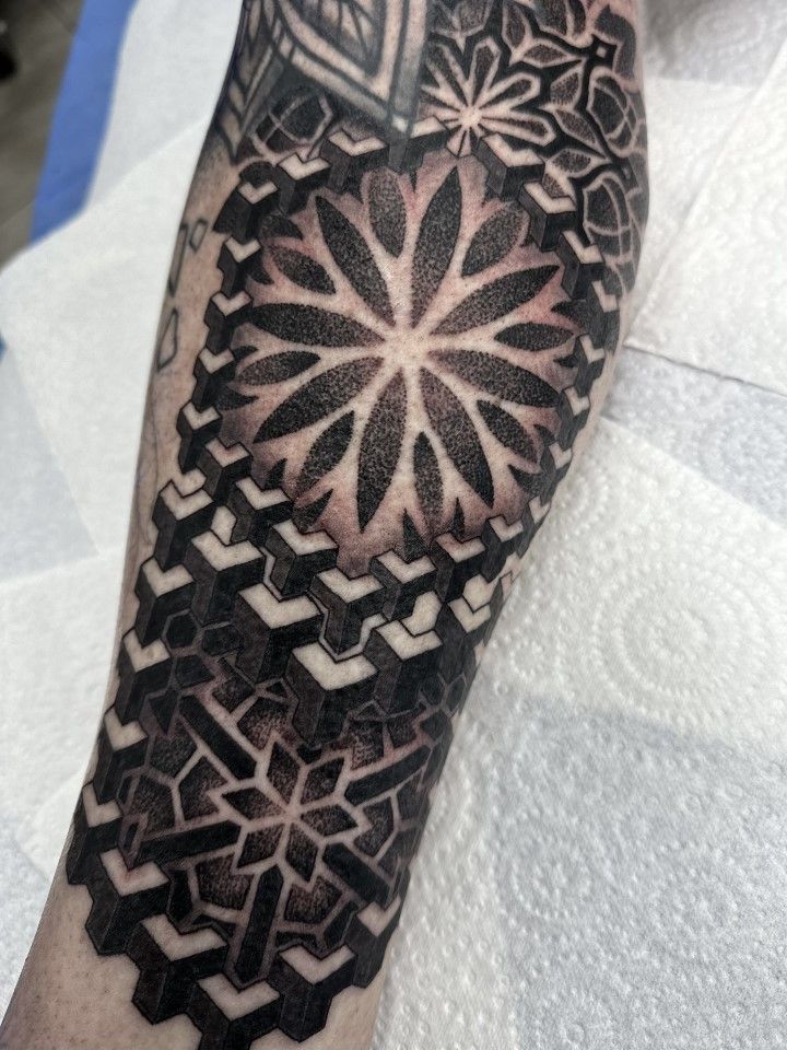 Tattoo on forearm, geometric black ink design: floral and interlocking shapes. — Whitsunday Tattooing Airlie Beach in Whitsundays, QLD