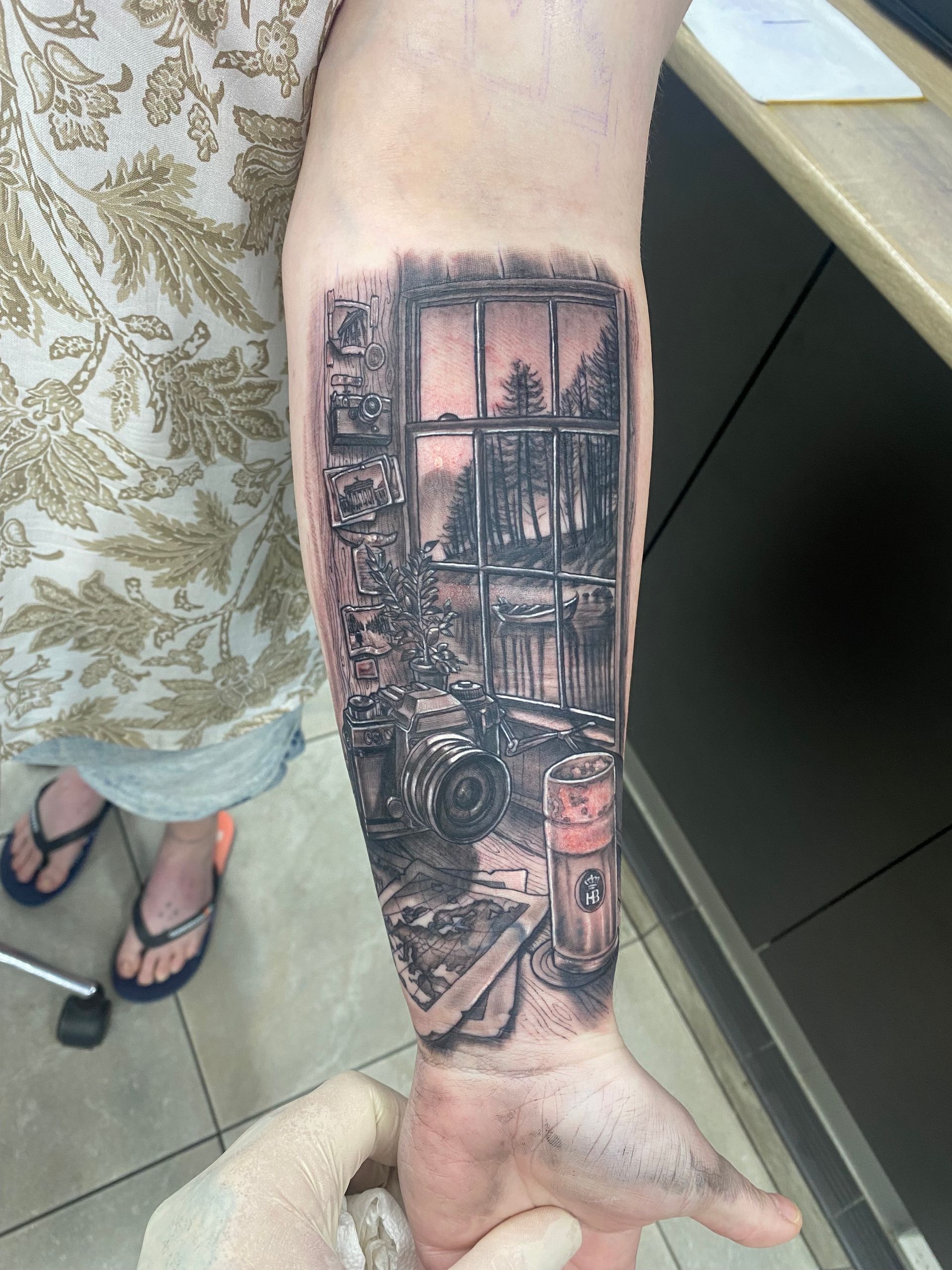 Tattoo on forearm: grayscale scene of a room interior with window view of trees. — Whitsunday Tattooing Airlie Beach in Whitsundays, QLD