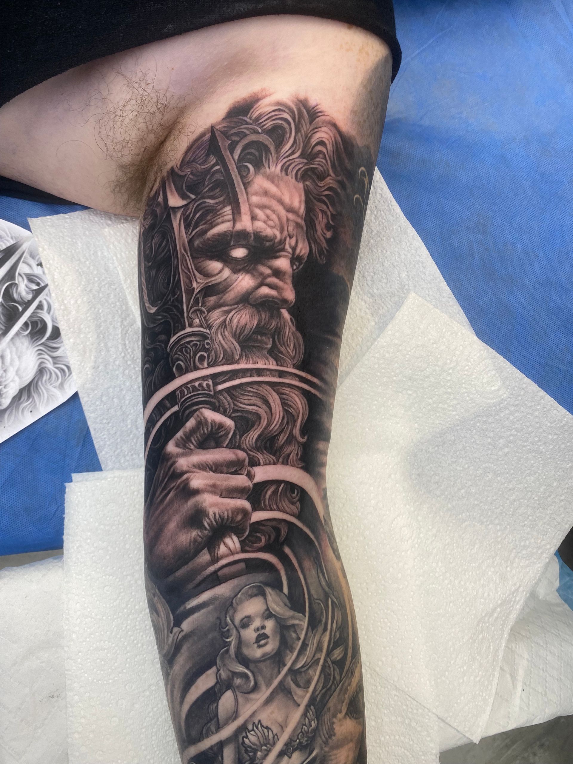Tattoo on forearm: Bearded figure with a sword, with a woman below. Black and white. — Whitsunday Tattooing Airlie Beach in Whitsundays, QLD