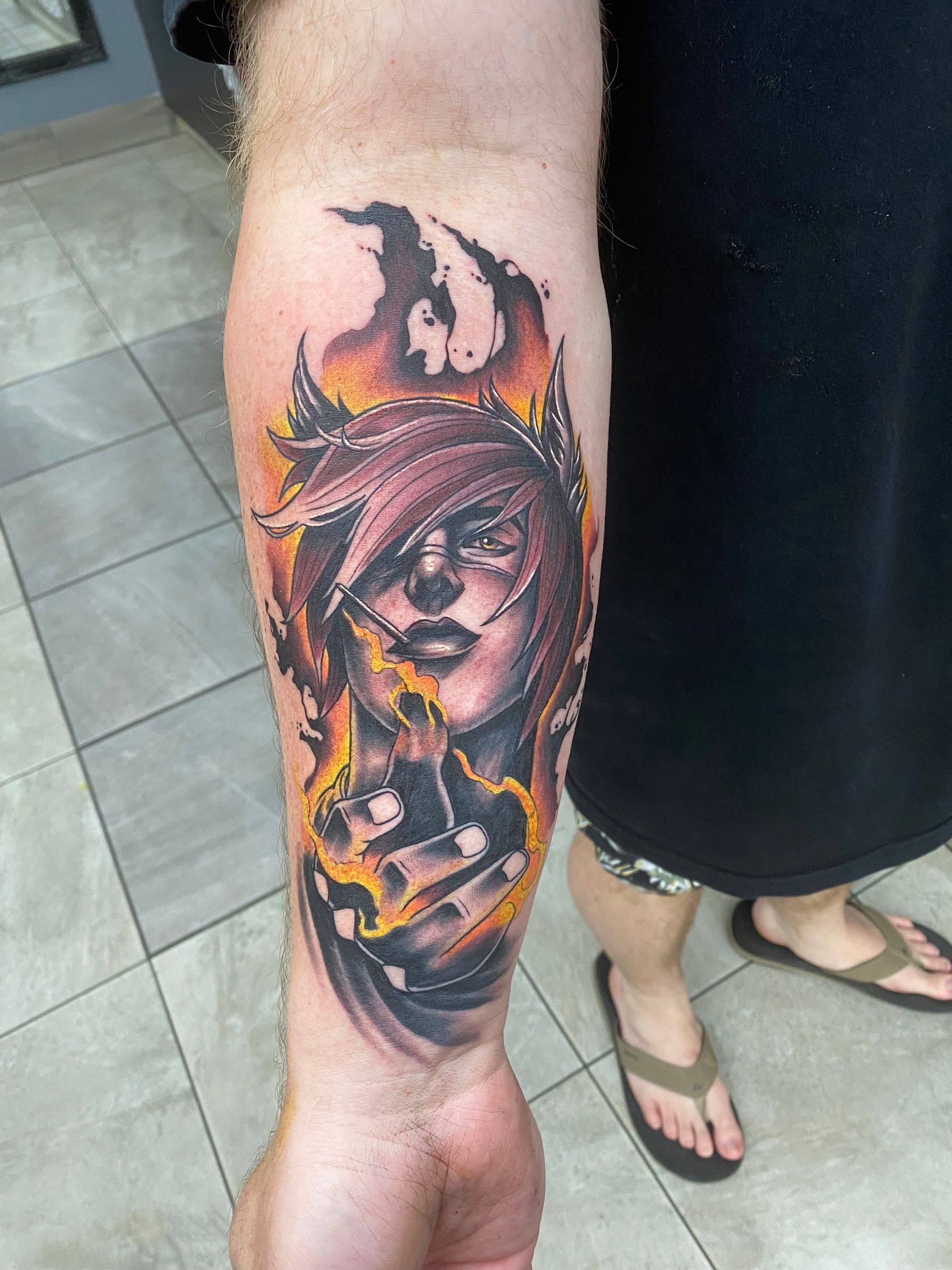 Tattoo of a person with purple hair and burning flames on forearm. — Whitsunday Tattooing Airlie Beach in Whitsundays, QLD