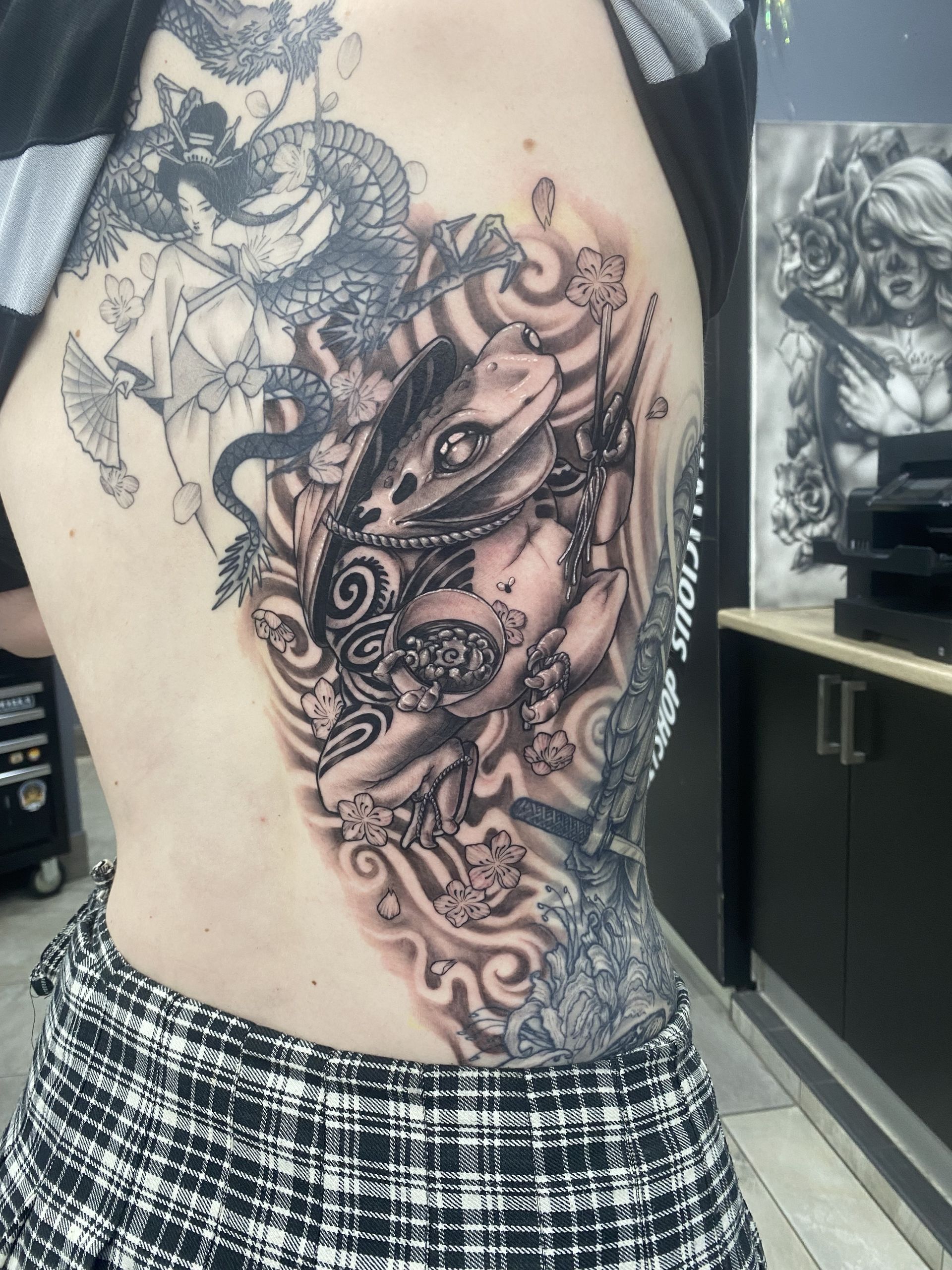 Tattoo on a Person's Side, Featuring a Creature and Floral Elements — Whitsunday Tattooing Airlie Beach in Airlie Beach, QLD