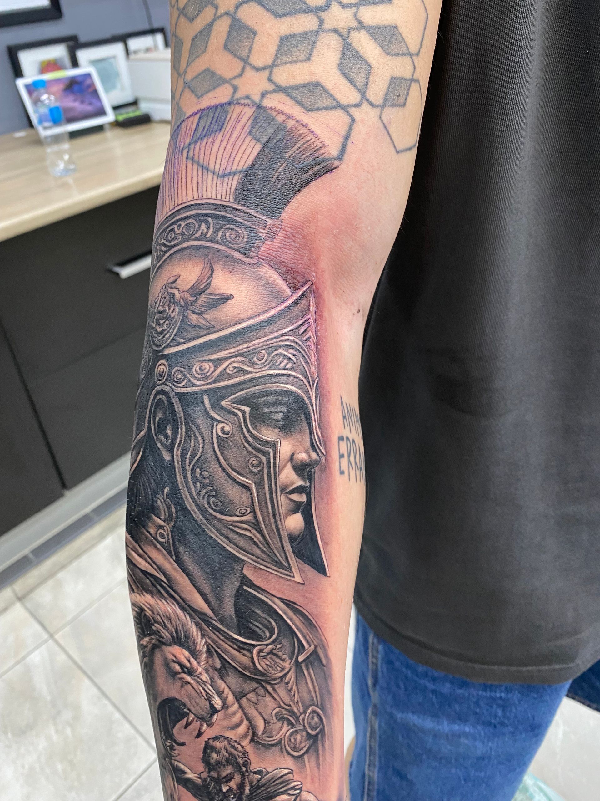 Tattoo of a Roman soldier on an arm, with a detailed helmet, in a tattoo studio setting. — Whitsunday Tattooing Airlie Beach in Whitsundays, QLD