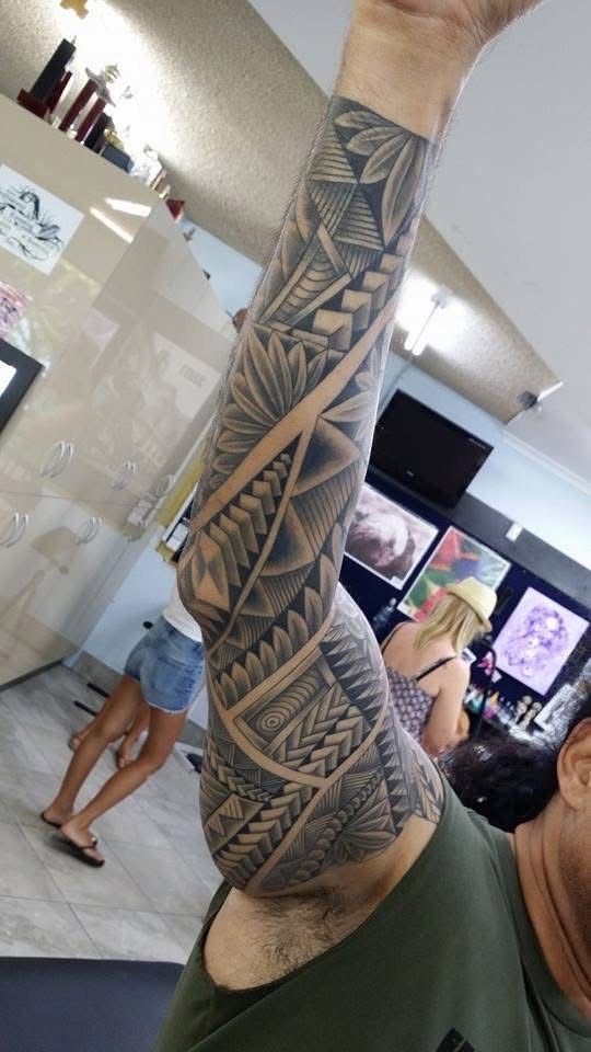 Tattoo of geometric patterns covering a person's arm. The setting appears to be a tattoo shop. — Whitsunday Tattooing Airlie Beach in Whitsundays, QLD