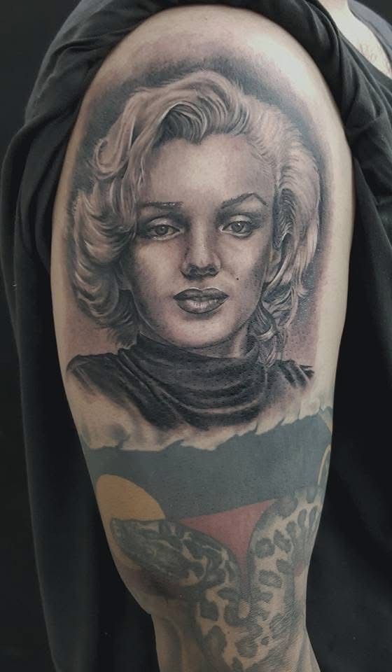 Black and grey tattoo of Marilyn Monroe on upper arm; a second, colorful tattoo below. — Whitsunday Tattooing Airlie Beach in Whitsundays, QLD